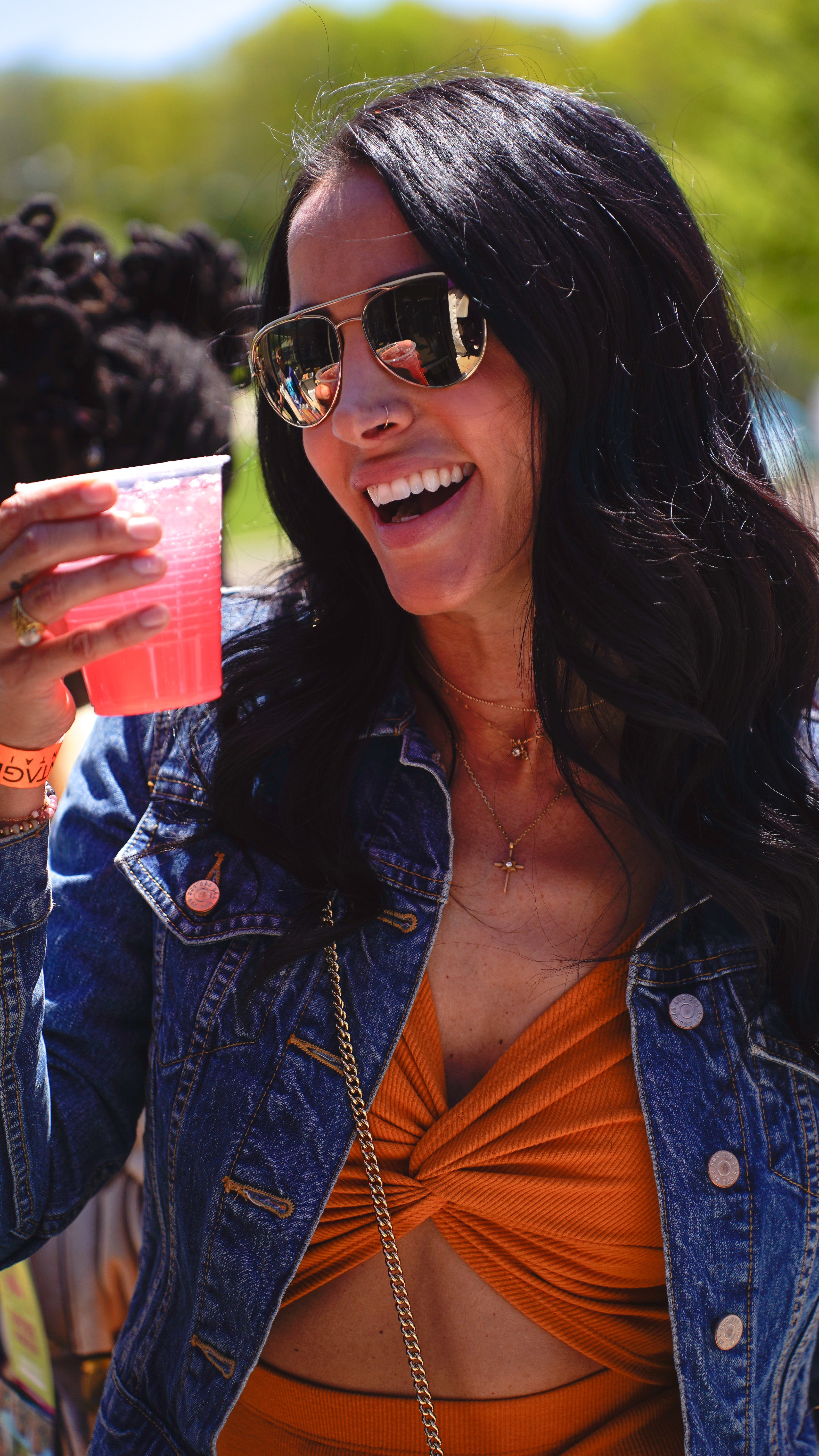 Guest holding a cocktail served at a Sylf activation